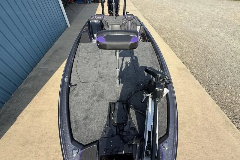 Slide: The Image of 2026 Skeeter ZXE20 fishing boat with trolling motor and seating, docked on concrete. - 25