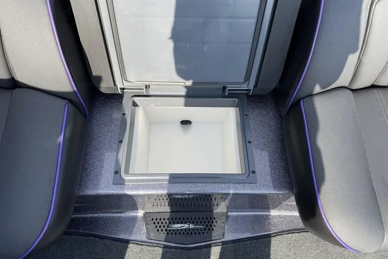 Slide: The Image of 2026 Skeeter ZXE20 boat interior with open storage compartment between seats. - 9