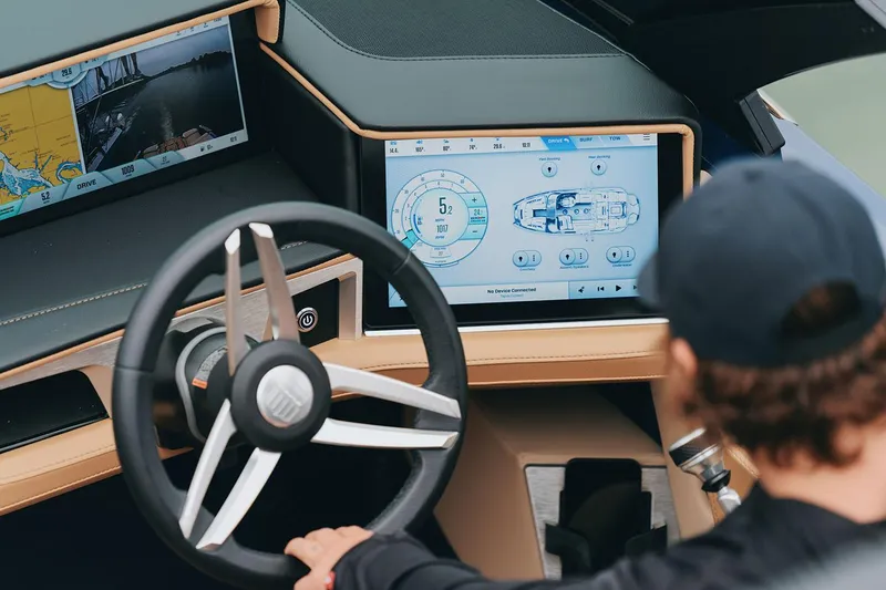 Slide: The Image of Manufacturer Provided Image: 2025 MasterCraft X24 boat dashboard with advanced navigation screens and steering wheel. - 10