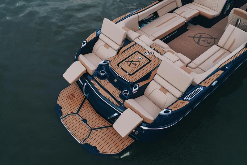 Slide: The Image of Manufacturer Provided Image: 2025 MasterCraft X24 boat with luxurious seating and sleek design on the water. - 11