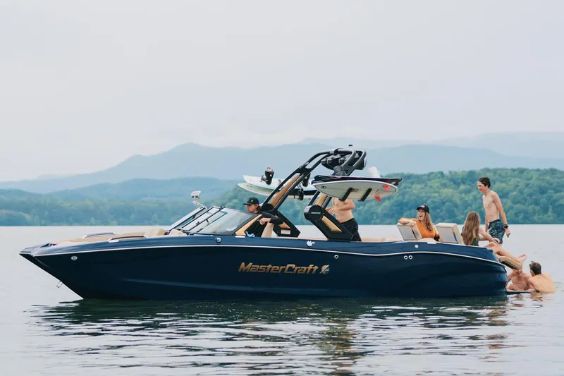 Slide: The Image of Manufacturer Provided Image: 2025 MasterCraft X24 boat on a lake with people enjoying the water. - 14