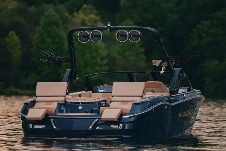 Slide: The Image of Manufacturer Provided Image: 2025 MasterCraft X24 boat on a serene lake with lush green background. - 15