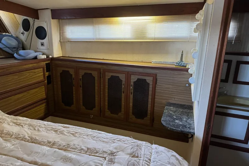 Slide: The Image of 1978 Viking 43 Aft Cabin interior with wood cabinetry and cozy bedding. - 11