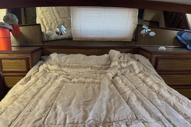 Slide: The Image of Cozy bedroom in 1978 Viking 43 Aft Cabin yacht with elegant bedding and wood accents. - 12