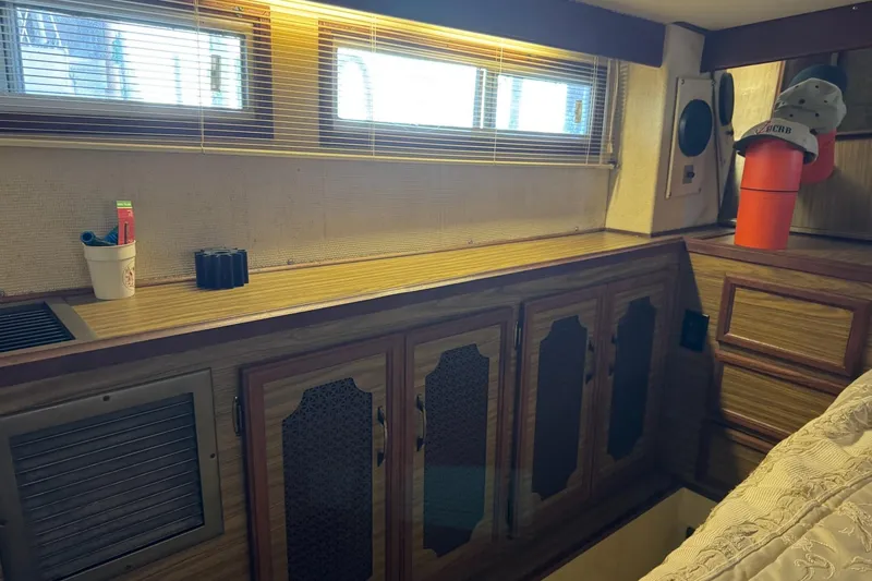 Slide: The Image of 1978 Viking 43 Aft Cabin interior with wood cabinets and windows. - 14