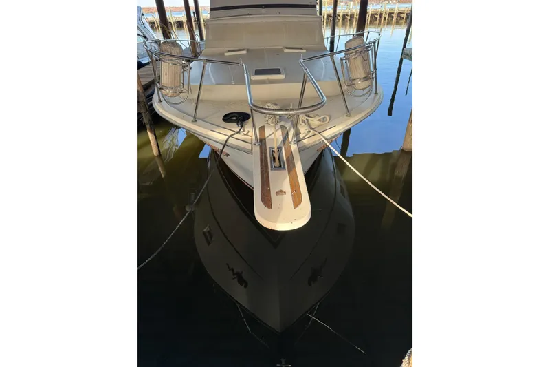 Slide: The Image of 1978 Viking 43 Aft Cabin yacht docked, reflecting on calm water. - 2