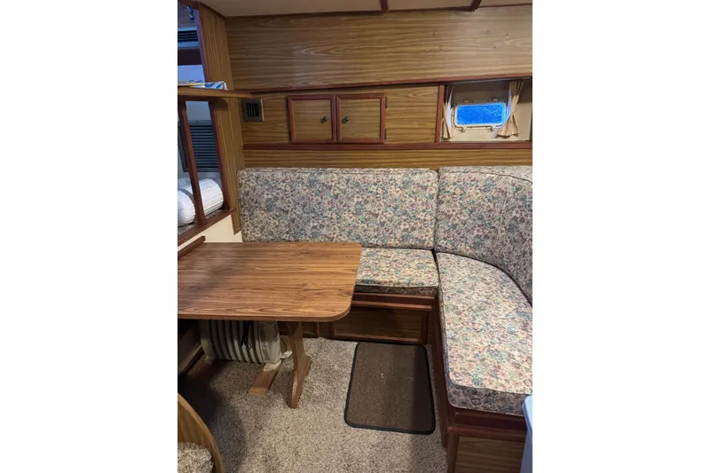 Slide: The Image of 1978 Viking 43 Aft Cabin interior with floral upholstery and wooden dining table. - 5