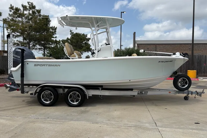 The Image of 2021 Sportsman Heritage 211 Center Console boat on trailer, parked outdoors. - 0