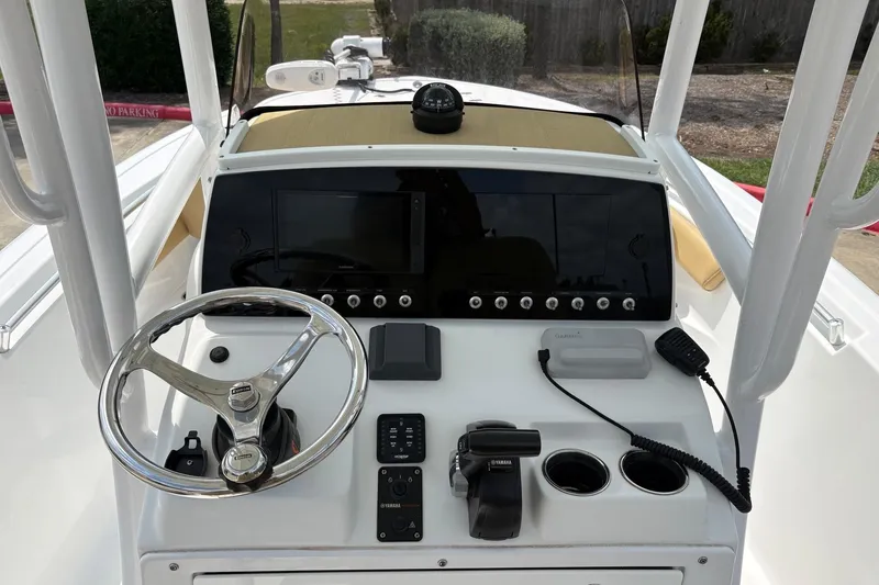 Slide: The Image of 2021 Sportsman Heritage 211 Center Console boat dashboard with steering wheel and controls. - 11