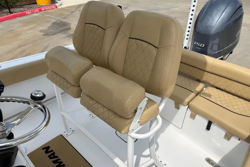 Slide: The Image of 2021 Sportsman Heritage 211 Center Console with tan cushioned seating and steering wheel. - 13