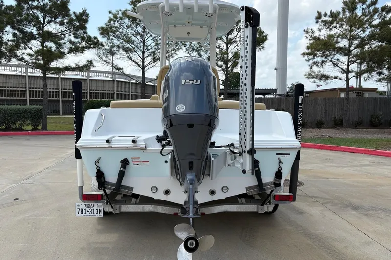 Slide: The Image of 2021 Sportsman Heritage 211 Center Console boat with Yamaha 150 engine, parked outdoors. - 16