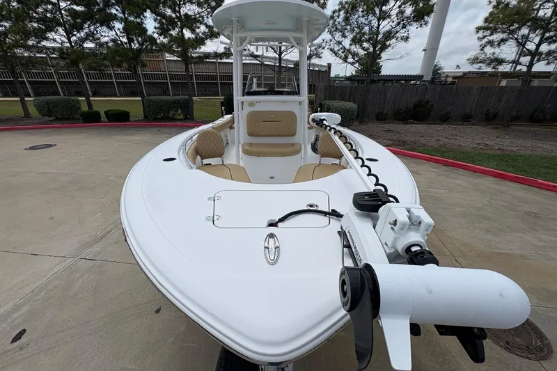 Slide: The Image of 2021 Sportsman Heritage 211 Center Console boat with trolling motor, parked outdoors. - 3