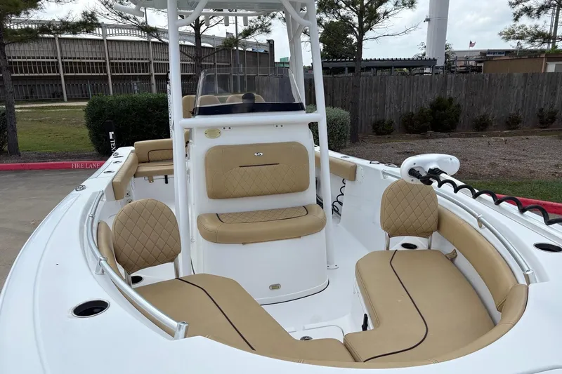 Slide: The Image of 2021 Sportsman Heritage 211 Center Console boat with tan seating and white exterior. - 5