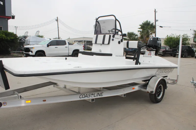 Slide: The Image of 2026 Freedom Boats 16' Eagle on trailer, parked outdoors. - 11