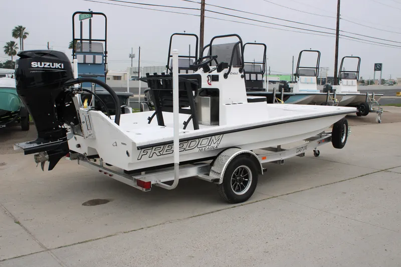 Slide: The Image of 2026 Freedom Boats 16' Eagle on trailer with Suzuki outboard motor. - 13