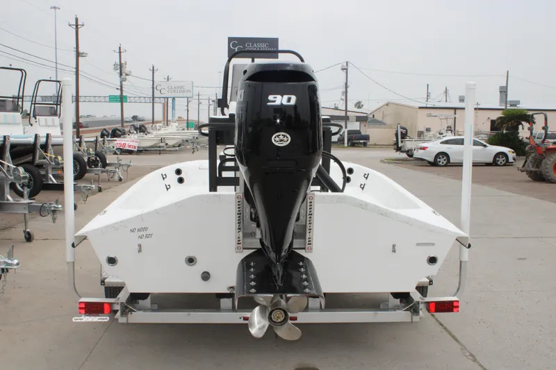 Slide: The Image of 2026 Freedom Boats 16' Eagle with 90 HP engine on trailer, rear view. - 14
