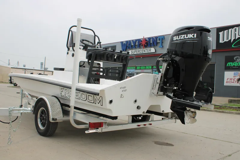 Slide: The Image of 2026 Freedom Boats 16' Eagle with Suzuki engine at dealership. - 15