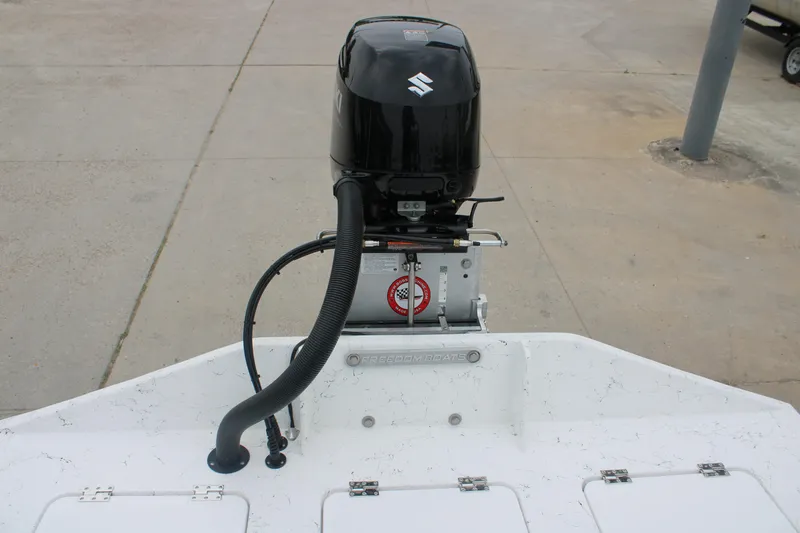 Slide: The Image of 2026 Freedom Boats 16' Eagle with Suzuki outboard motor, rear view. - 8