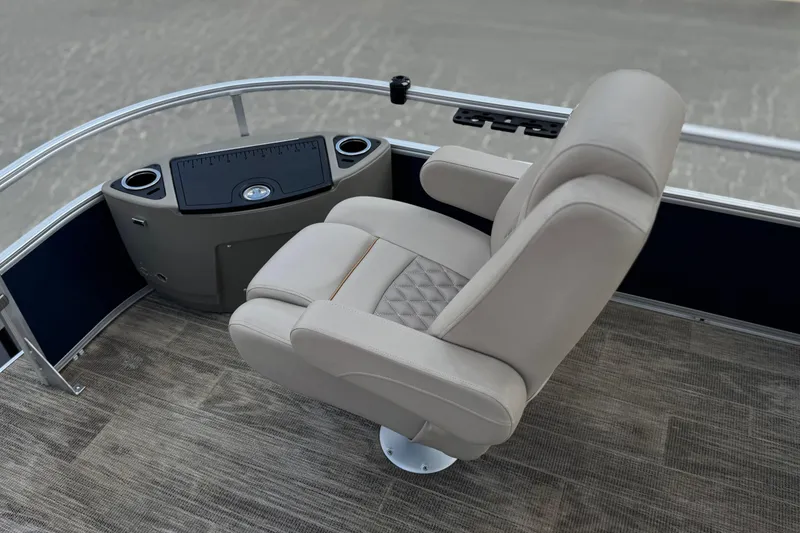 Slide: The Image of 2024 Ranger Reata 223F boat interior with plush captain's chair and control panel. - 12