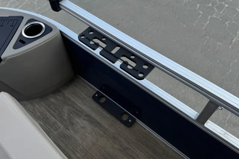 Slide: The Image of Interior view of 2024 Ranger Reata 223F boat, featuring cup holder and railing. - 13