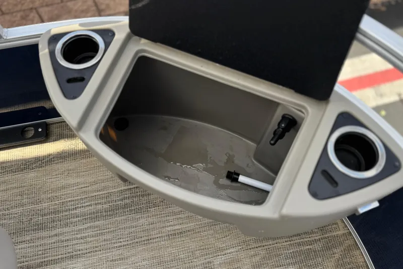 Slide: The Image of 2024 Ranger Reata 223F boat compartment with cup holders and storage space. - 14