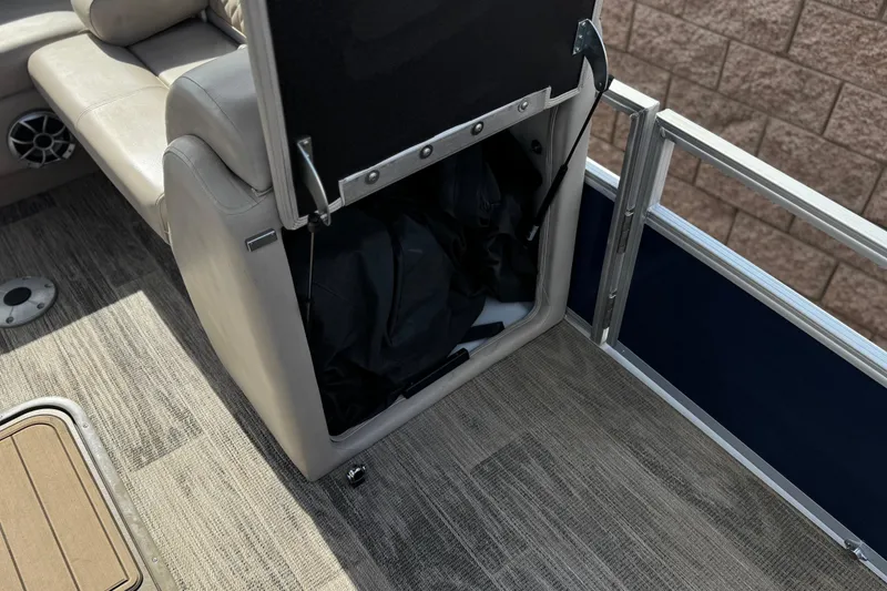 Slide: The Image of 2024 Ranger Reata 223F boat interior with storage compartment and seating. - 18