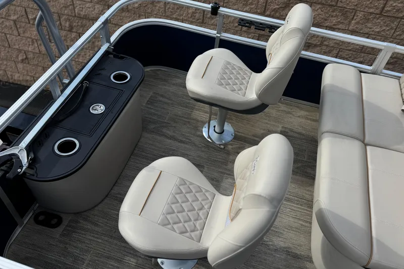 Slide: The Image of 2024 Ranger Reata 223F boat interior with beige seating and cup holders. - 21