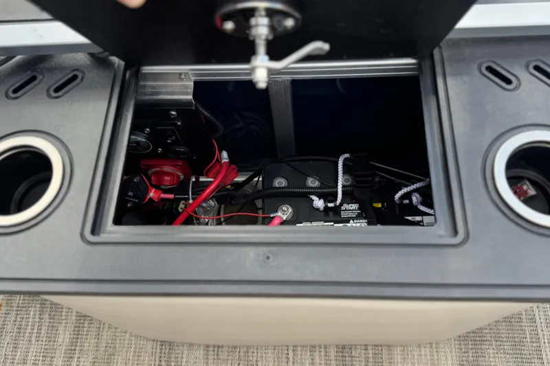 Slide: The Image of Battery compartment of 2024 Ranger Reata 223F boat with wiring and controls. - 22