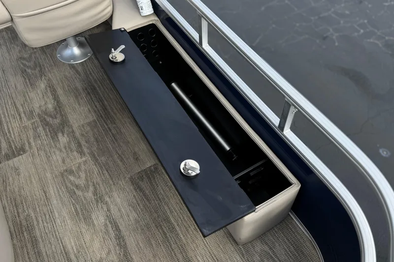Slide: The Image of 2024 Ranger Reata 223F boat storage compartment with open lid, showcasing interior space. - 25