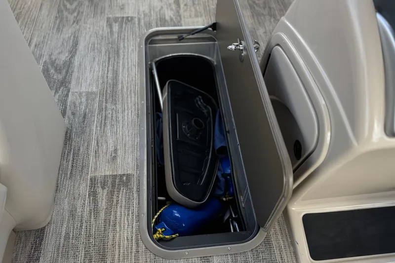 Slide: The Image of Storage compartment on 2024 Ranger Reata 223F boat, containing water sports equipment. - 27