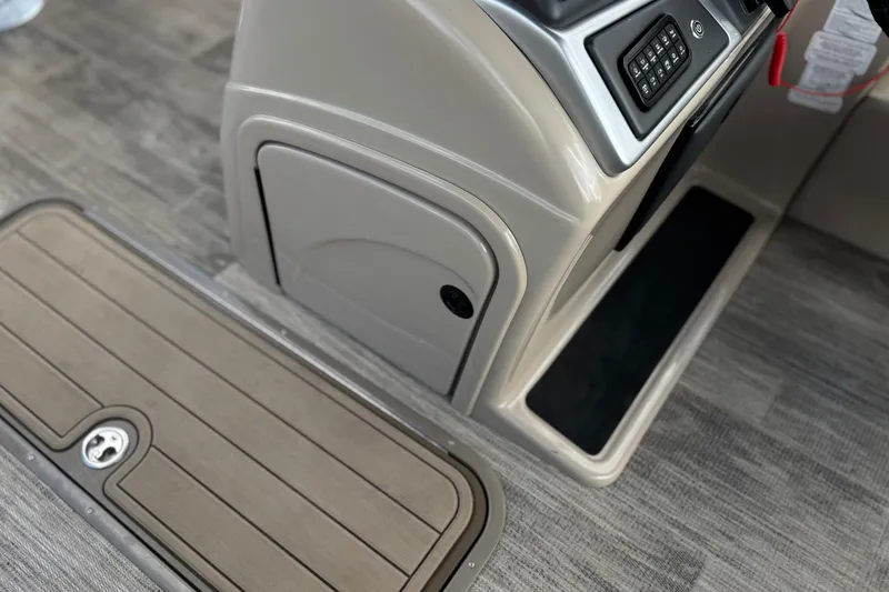 Slide: The Image of 2024 Ranger Reata 223F boat interior with control panel and storage compartment. - 32