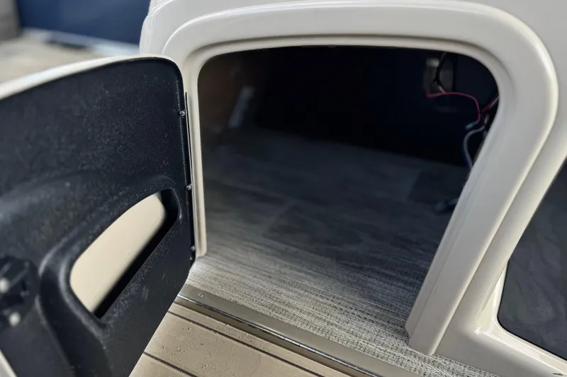 Slide: The Image of Open storage compartment on 2024 Ranger Reata 223F boat, showcasing interior space and wiring. - 33