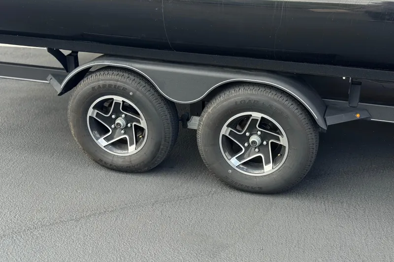 Slide: The Image of 2024 Ranger Reata 223F trailer wheels on asphalt surface. - 34