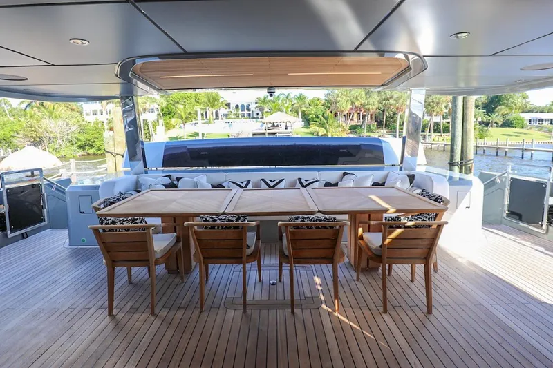 Slide: The Image of Luxurious 2025 Majesty 120 yacht deck with elegant dining area and scenic views. - 31