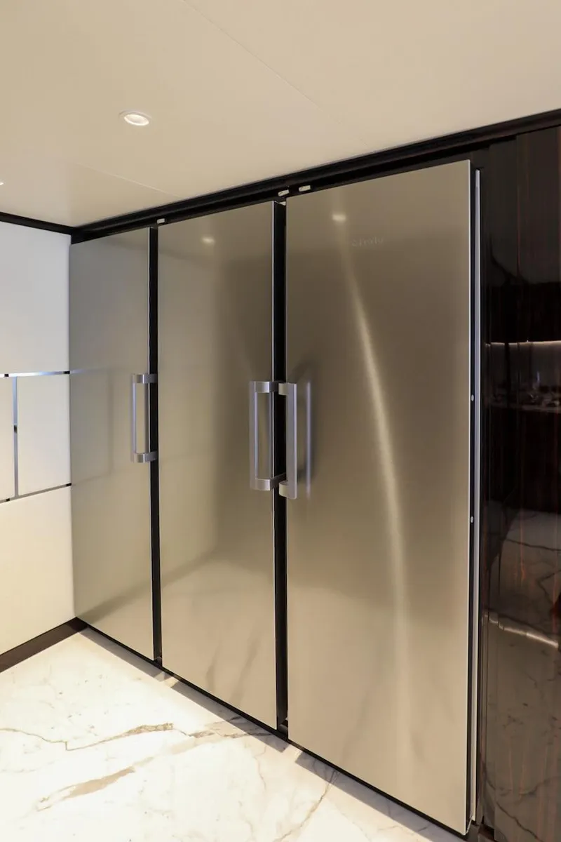 Slide: The Image of Sleek 2025 Majesty 120 yacht interior with modern stainless steel appliances. - 41