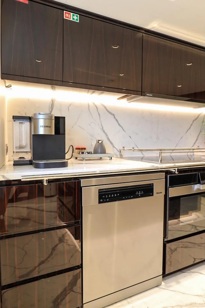Slide: The Image of Modern kitchen with marble backsplash, sleek cabinetry, and high-end appliances on a Majesty 120 yacht. - 44