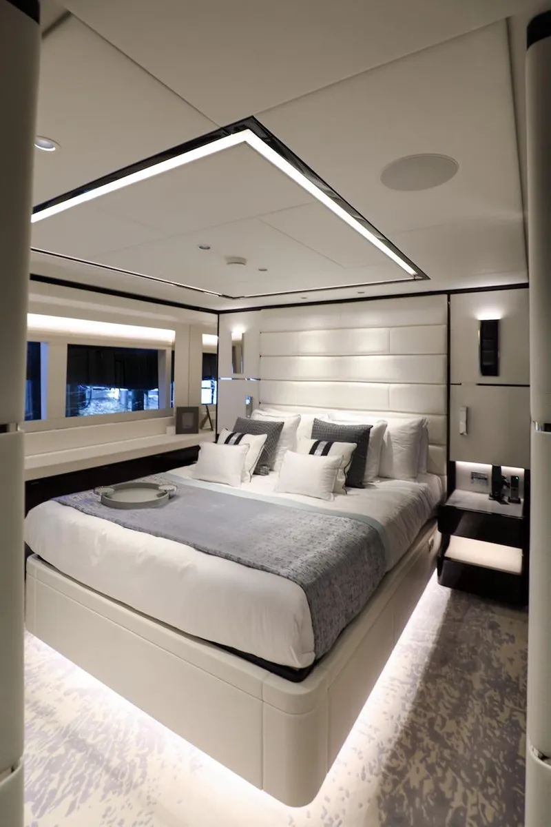 Slide: The Image of Luxurious bedroom interior on 2025 Majesty 120 yacht, featuring modern design and elegant lighting. - 45
