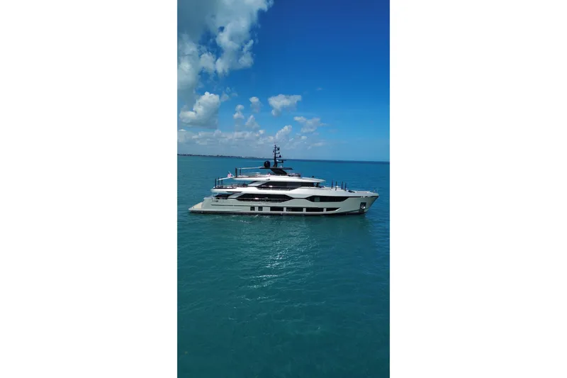 Slide: The Image of Luxurious 2025 Majesty 120 yacht cruising on clear blue ocean waters. - 95