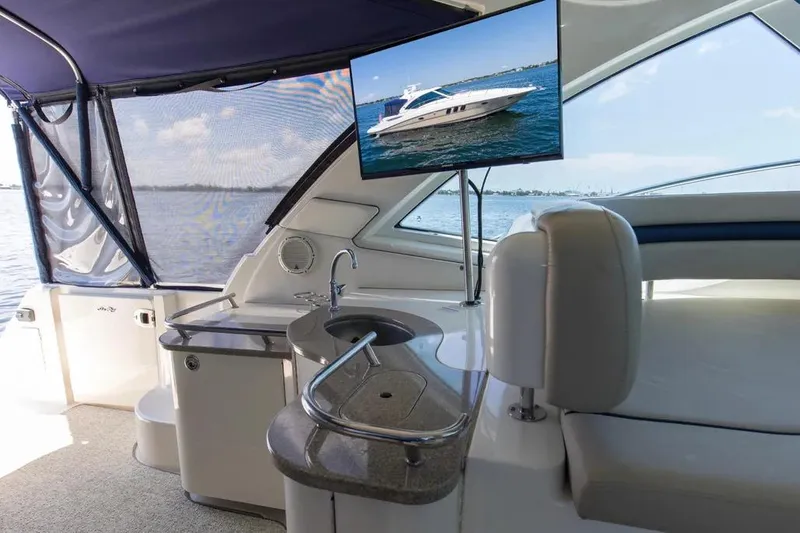 Slide: The Image of Luxurious 2006 Sea Ray 48 Sundancer yacht interior with TV and kitchenette. - 11