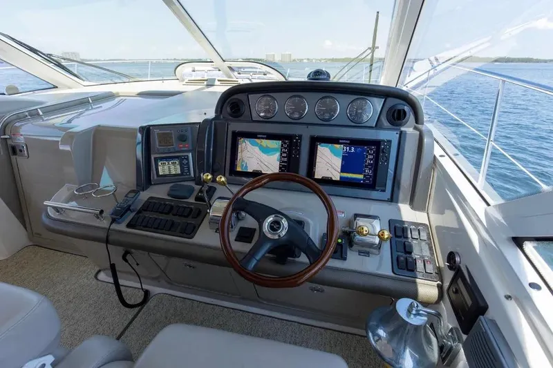 Slide: The Image of Helm of 2006 Sea Ray 48 Sundancer yacht with navigation screens and controls. - 15