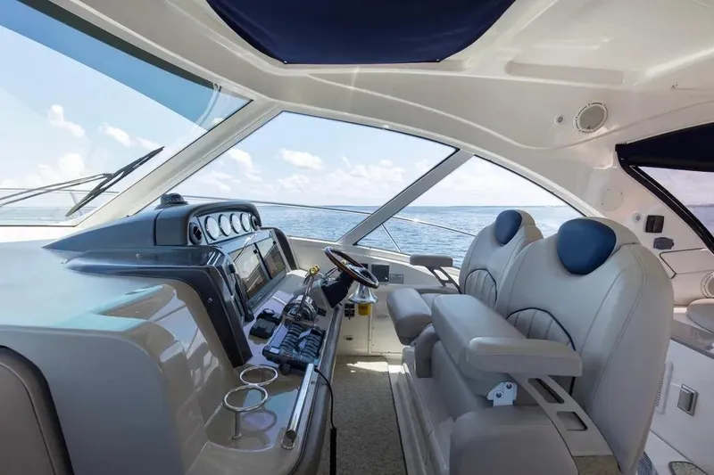 Slide: The Image of Interior view of 2006 Sea Ray 48 Sundancer yacht cockpit with luxurious seating and ocean view. - 16