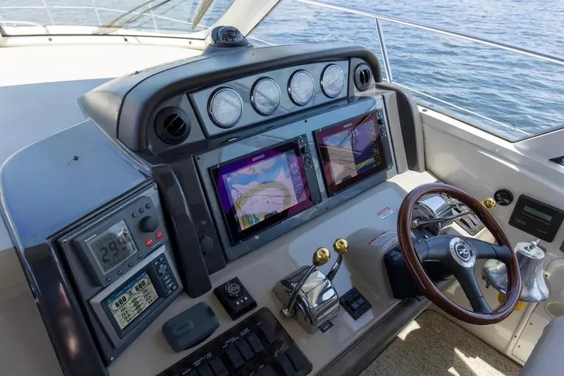 Slide: The Image of Helm of 2006 Sea Ray 48 Sundancer with navigation screens and controls. - 17