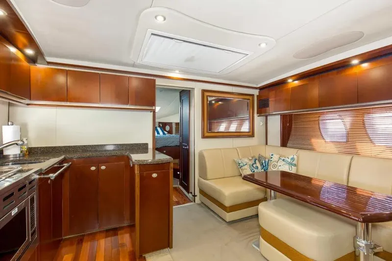 Slide: The Image of Luxurious interior of 2006 Sea Ray 48 Sundancer yacht with elegant wood finishes and plush seating. - 21