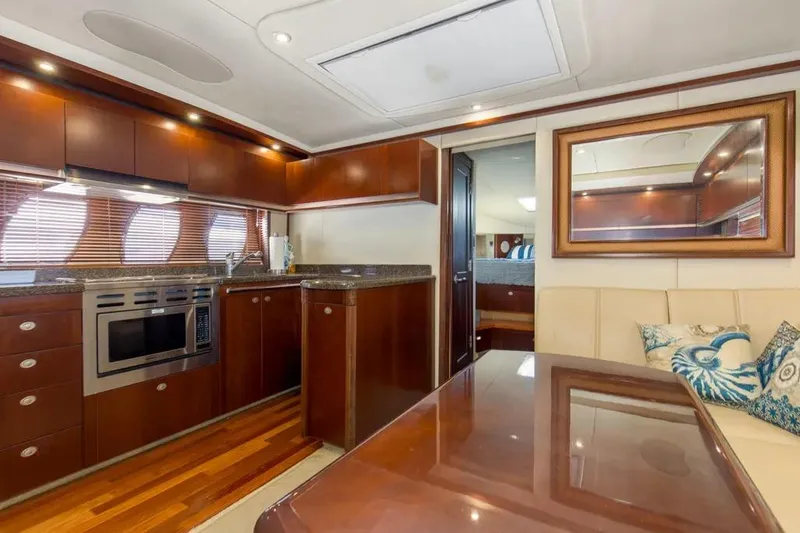 Slide: The Image of Luxurious interior of 2006 Sea Ray 48 Sundancer yacht with modern kitchen and seating area. - 26