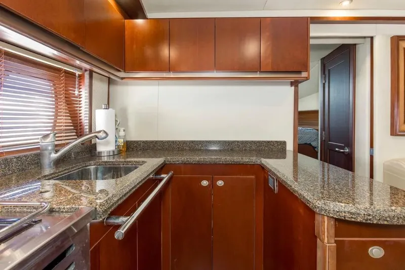 Slide: The Image of Luxurious kitchen interior of 2006 Sea Ray 48 Sundancer yacht with granite countertops. - 27