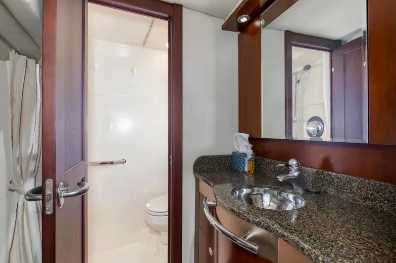 Slide: The Image of Luxurious bathroom in 2006 Sea Ray 48 Sundancer yacht with granite countertop and shower. - 31