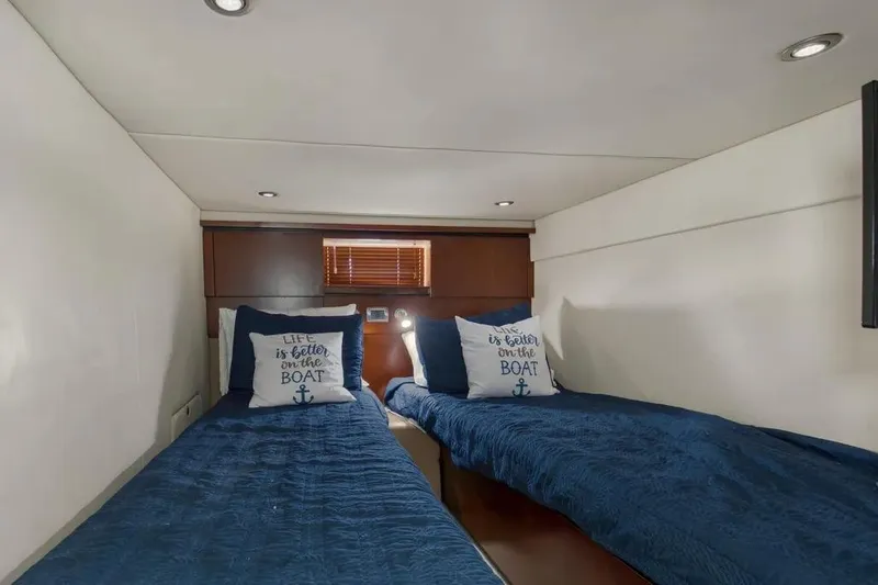 Slide: The Image of Interior cabin of 2006 Sea Ray 48 Sundancer with twin beds and nautical decor. - 32