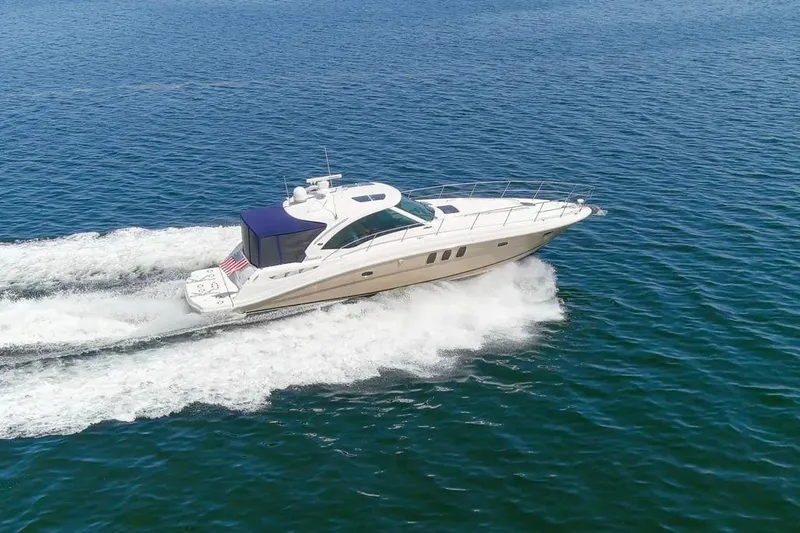 Slide: The Image of 2006 Sea Ray 48 Sundancer cruising on open water, showcasing sleek design and performance. - 4