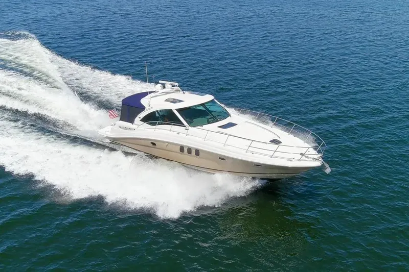 Slide: The Image of 2006 Sea Ray 48 Sundancer cruising on open water, showcasing sleek design and powerful performance. - 5