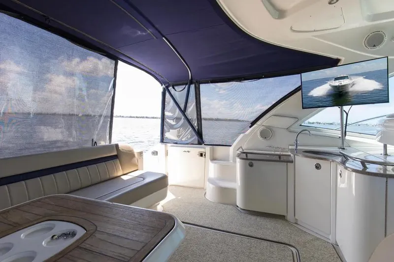 Slide: The Image of Luxurious interior of 2006 Sea Ray 48 Sundancer yacht with seating and entertainment area. - 9